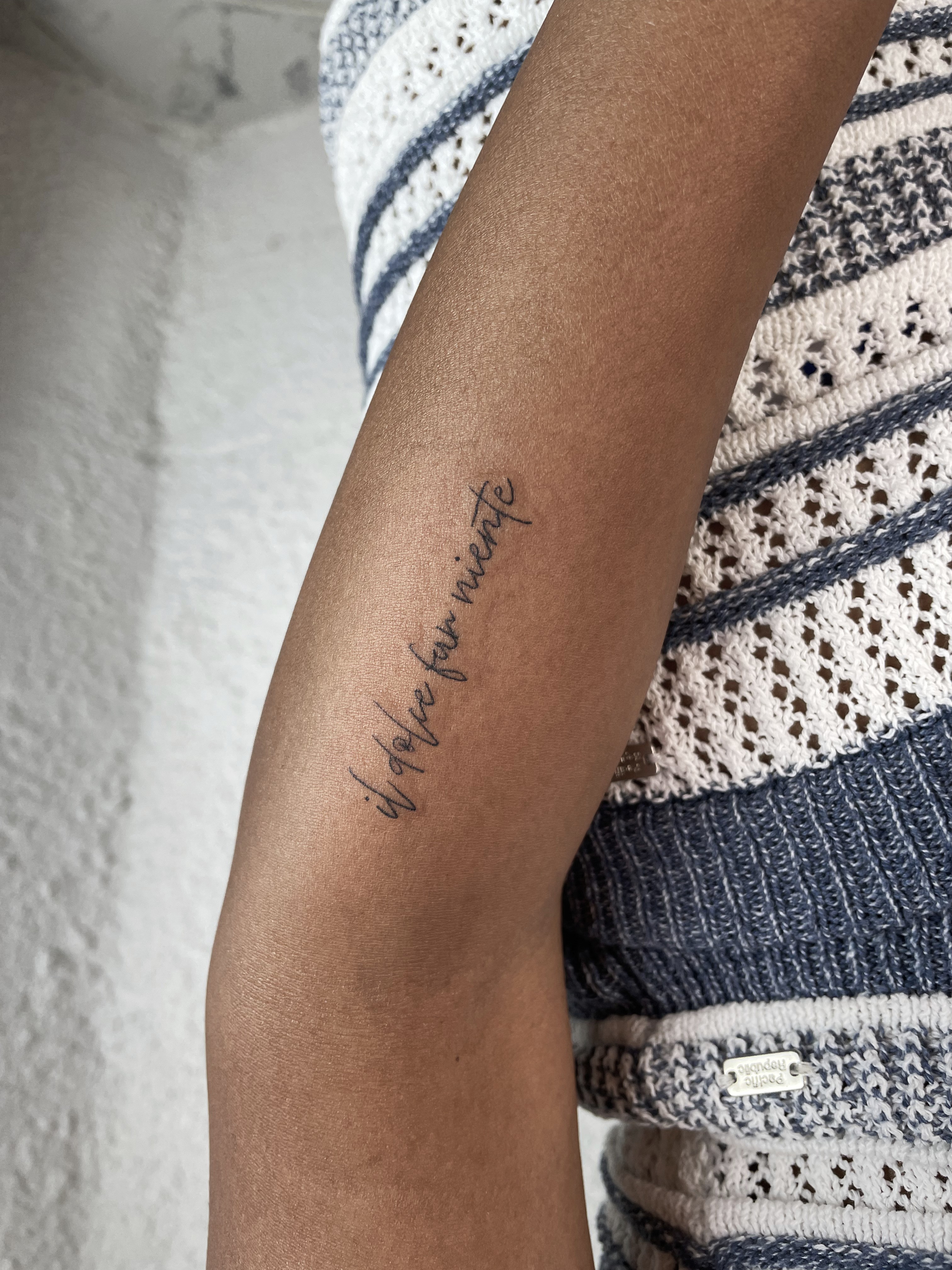 minimalist handwritten script tattoo on the forearm