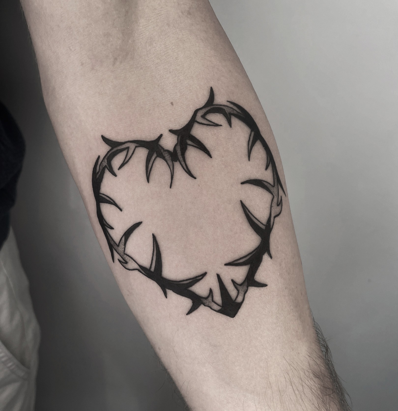 thorn heart tattoo in bold blackwork style
